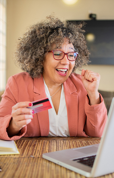 Woman online shopping on her laptop with credit card