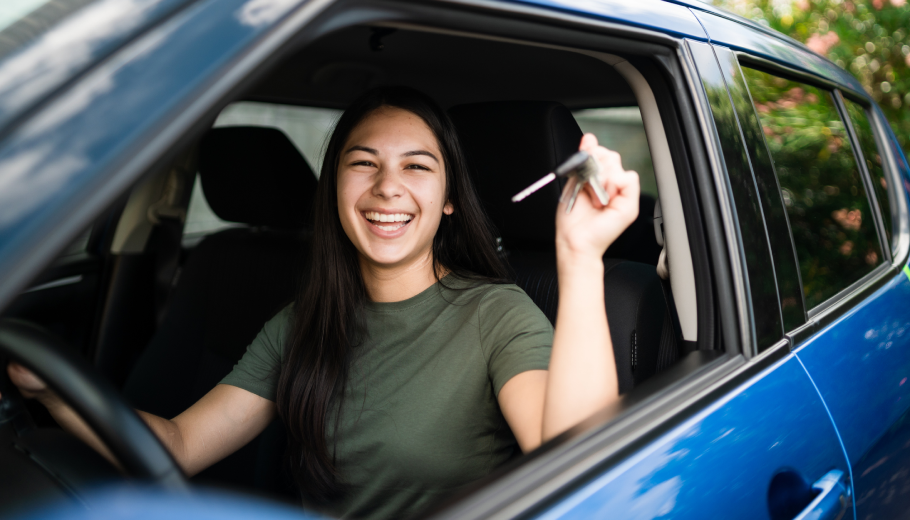 Young female driver in car