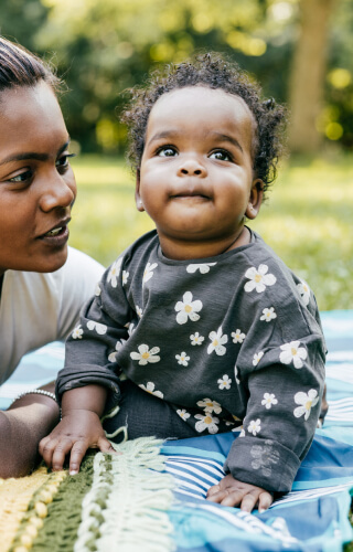 Baby girl with mother in park