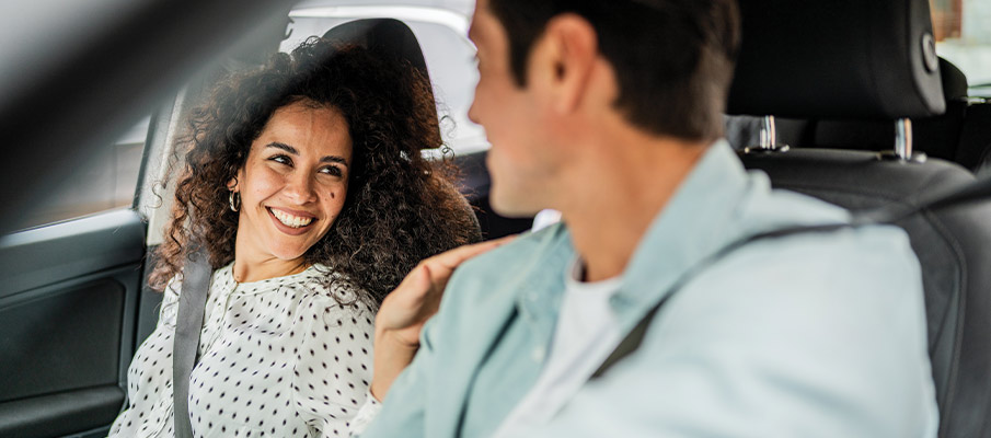 Couple in Car Smiling at Each Other