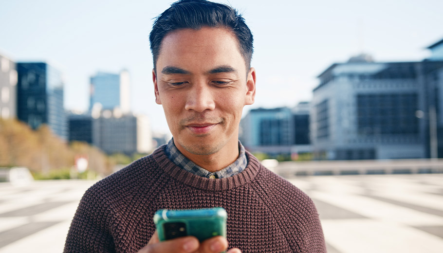 Man looking at his phone outside