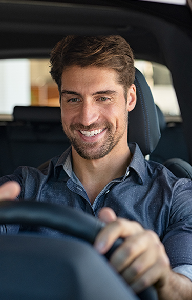 Man driving a car smiling