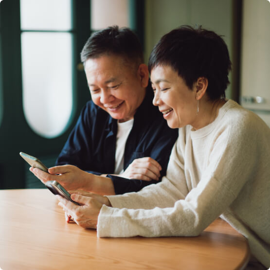 Mature couple using mobile phones