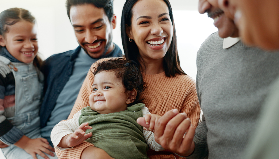 multi-generational family with baby smiling and happy