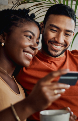 Young couple using debit/credit card online