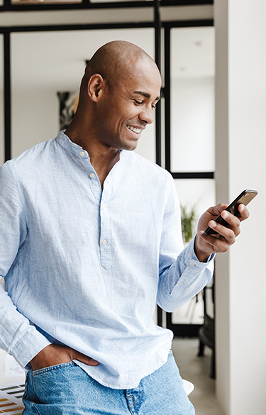 Man looking at cell phone smiling