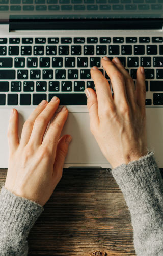 hands on laptop keyboard