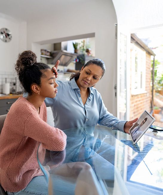 Mother with sick daughter on video call with doctor