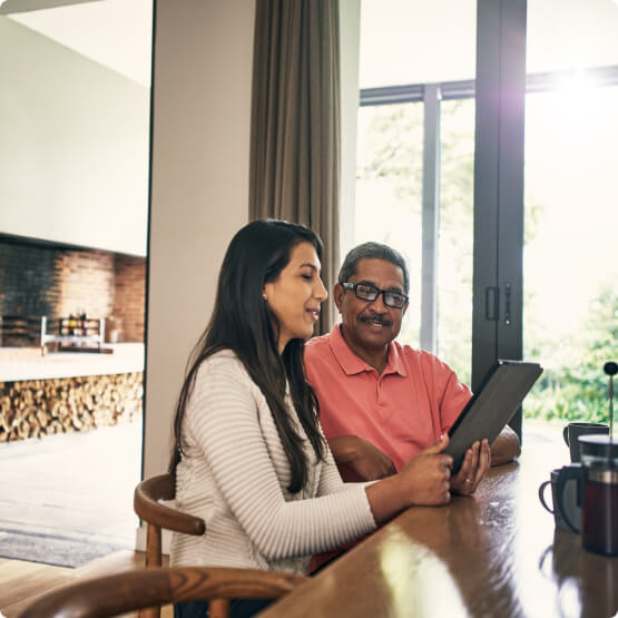 Couple looking at a tablet in their home