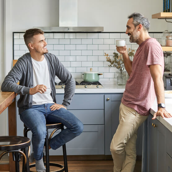 Two men in casual conversation in kitchen