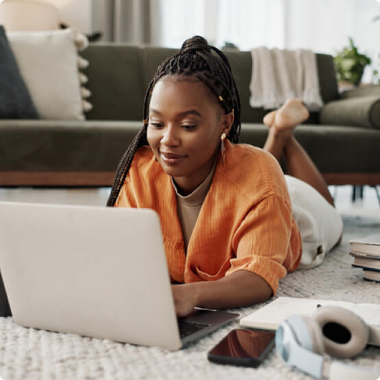 Woman relaxing in the living room with a laptop