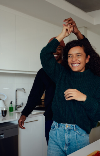 young couple dancing in kitchen 