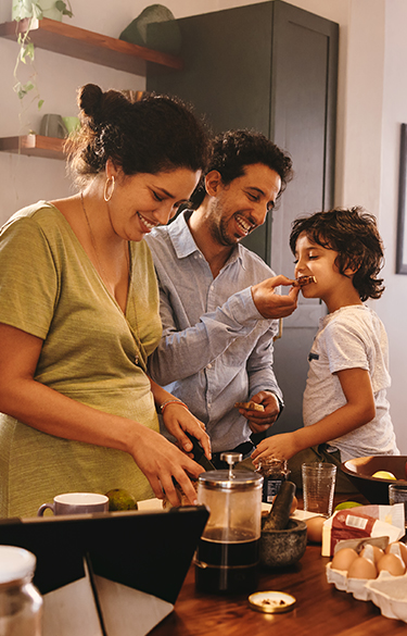 Family eating at kitchen island laughing