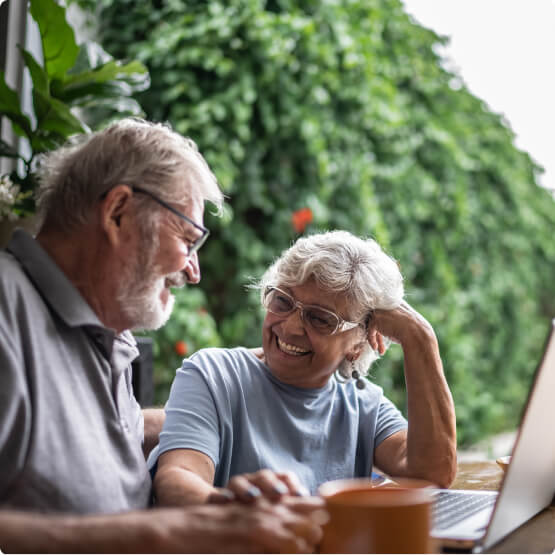 Mature couple at table with laptop