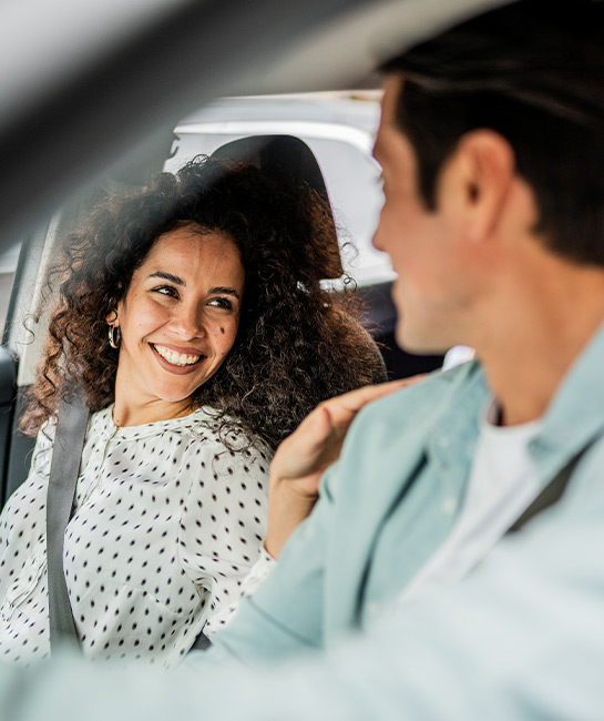 Couple in Car Smiling at Each Other