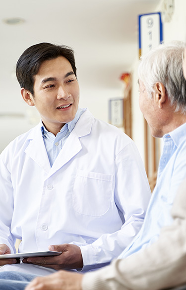 Male doctor talking with a senior male patient