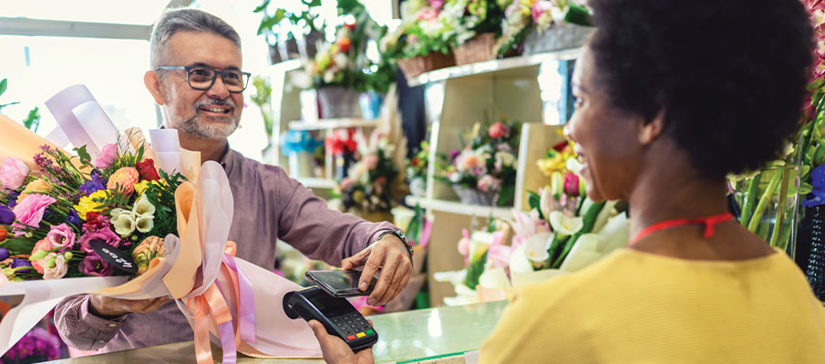 Man purchasing flower bouquet in shop 